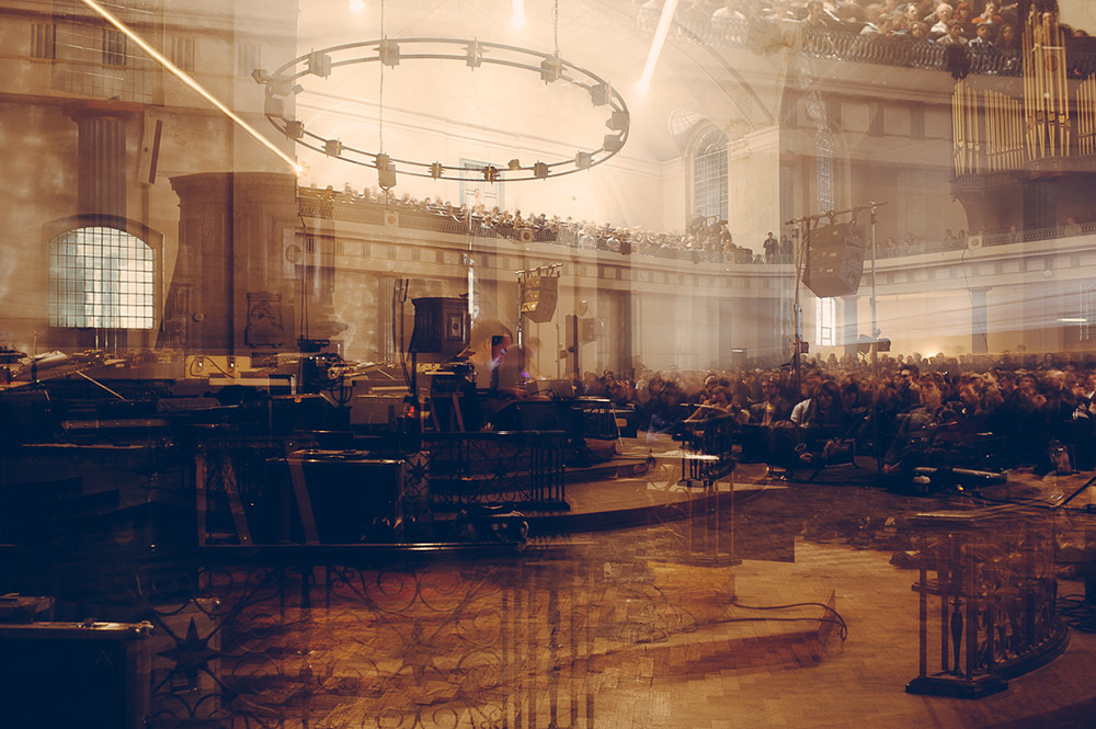 Double-exposed image of a concert in a domed church interior